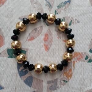 One gold&blk bracelet without charm